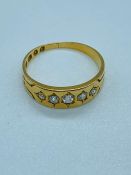 An 18 ct gold and five stone ring (3.4g) Size P