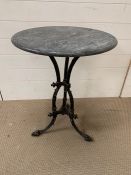 A Victorian cast iron garden table (H71cm Dia 56cm) with marble top