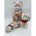 Three oriental ornamental cats.
