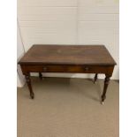 A regency mahogany writing table on turned tapering legs (H77cm W120cm D60cm)