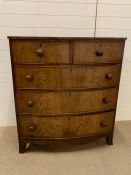 A bow front two over three mahogany chest of drawers (H114cm W102cm D50cm)