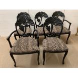 Six black framed dining chairs with an interesting flower design to back