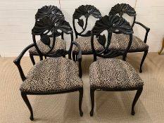 Six black framed dining chairs with an interesting flower design to back