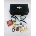 A selection of five watches, some coins and a locket in a musical jewellery box