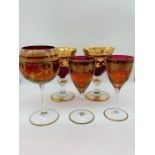 A selection of red and gold wine glasses/goblets