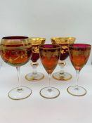 A selection of red and gold wine glasses/goblets
