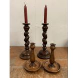 A pair of oak barley twist candle sticks (H30cm), and a pair of wooden turned candle holders (