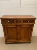 A mahogany side cupboard on bun feet with three drawers to top (H140cm W136cm D50cm)