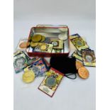 A Variety of collectable coins and medallions in a biscuit tin