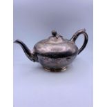 A white metal tea pot with acorn finial on lid (repair to base)