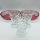 Two decorative rose coloured glass shallow bowls and three pretty sundae glasses