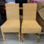A pair of wicker dining chairs