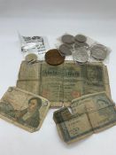 A small box of collectable crowns, a two pound coin and three banknotes.