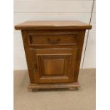 A bedside cabinet with drawer