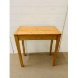 A pine desk with hinged lid (H76cm W73cm D40cm)