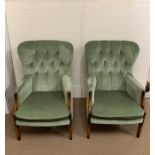 A pair of button back fireside chairs in green upholstery by Hypnos