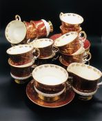 A "Sovereign" Elizabeth gold and maroon Staffordshire, twelve cup and saucers, twelve tea plates,