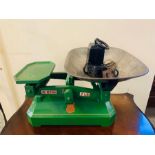 A green Co Op weight scales and weights