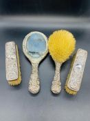 A Set of four hallmarked silver backed dressing table brushes.