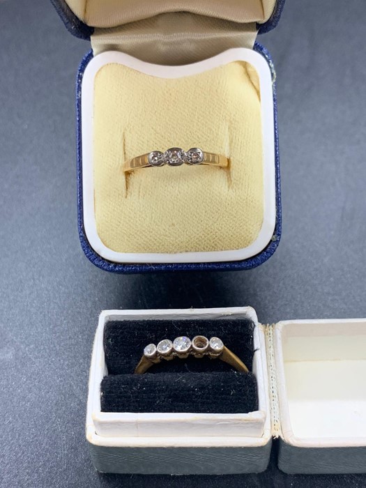 An 18 gold ring with missing stone (1.74g) and a three stone gold and platinum ring (2 g)