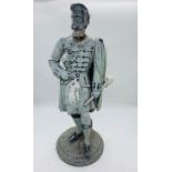 A metal statue of a Scottish highlander from the porridge oats factory