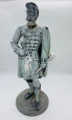 A metal statue of a Scottish highlander from the porridge oats factory