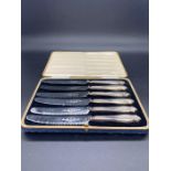 A Boxed set of silver handled butter knives