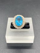 A Blue Topaz and diamond ring in 9 ct gold setting. (Size: Q)