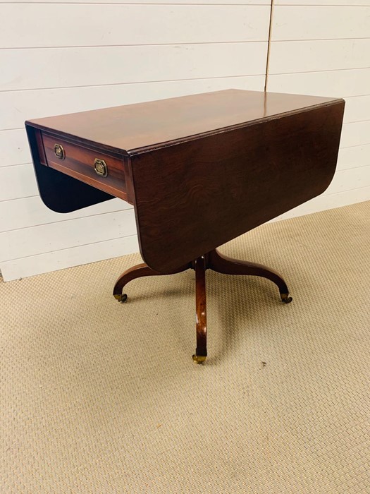 A mahogany Pembroke table with drop sides and down swept legs