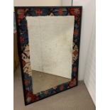 Foxed mirror with a kilim rug surround