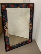 Foxed mirror with a kilim rug surround