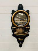 Wall mounted mirror and candle holder.