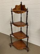 Mahogany four tier corner whatnot, of tapering form. Each serpentine front inlaid with fruitwood and