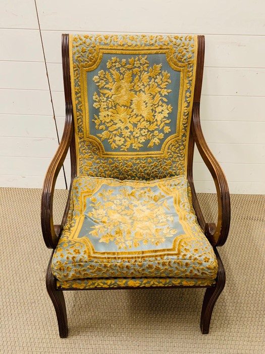 An open armchair with scroll arms