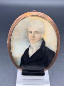 An Oval Framed Miniature of a Gentleman with a framed lock of hair to rear of frame.