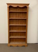 A large open pine bookcase