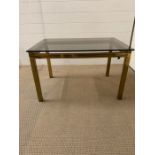 A Brass and Glass Table in the style of Maison Johnson.