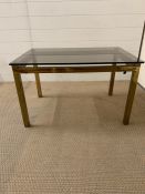 A Brass and Glass Table in the style of Maison Johnson.