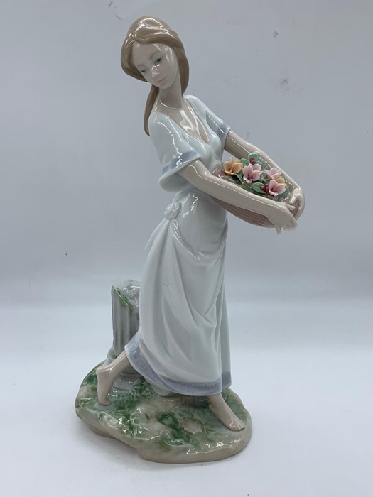 A Lladro figure of a girl holding flowers "Privilege Society 2004 1BY45"