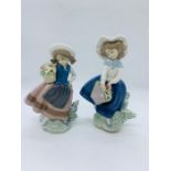 Two Lladro figurines of girls holding flowers