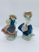 Two Lladro figurines of girls holding flowers