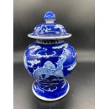 An oriental blue and white dragon design lidded pot