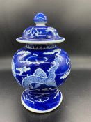 An oriental blue and white dragon design lidded pot