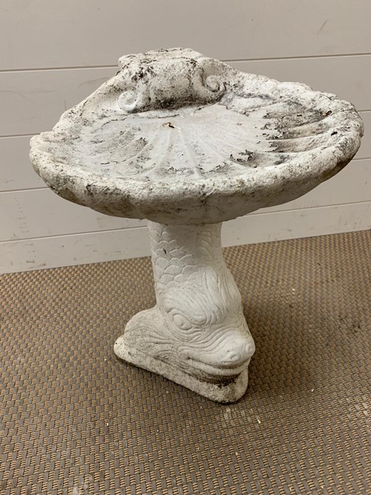 A garden bird bath of a fish holding a clam shell. Height 50cm