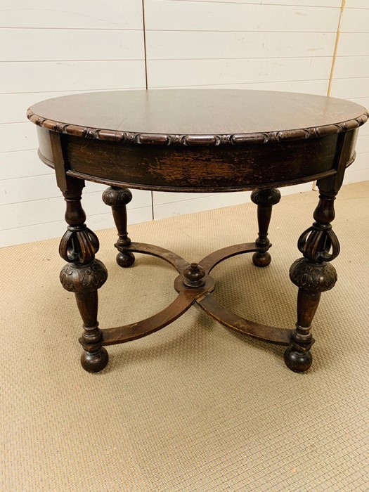 An oak centre table with carved legs and stretcher