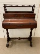 A mahogany writing table with an arrangement of drawers on scroll legs