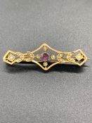 A Gold Brooch with amethyst