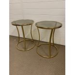 Pair of round gold metal framed side tables with smoked glass