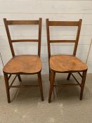 A pair of wooden kitchen chairs