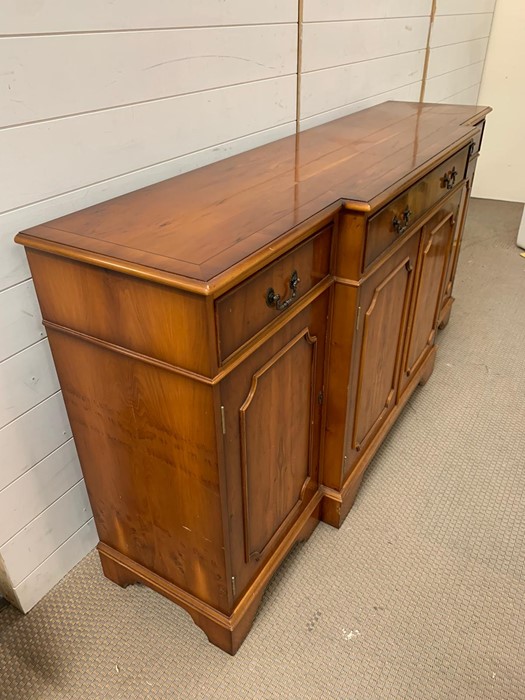 A Yew wood sideboard with double doors to centre flanked by single cupboards and three drawers H87cm - Image 4 of 4